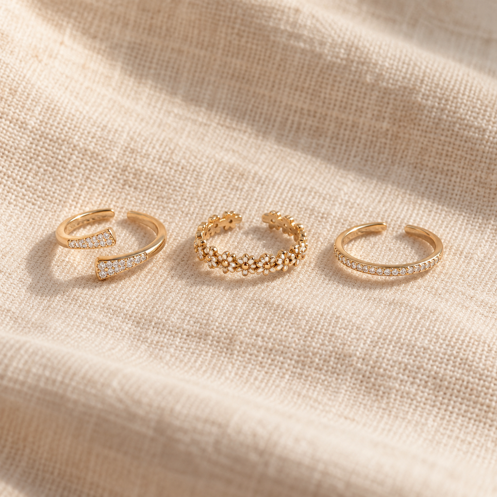 Daisy and crystal toe ring set laid out on linen