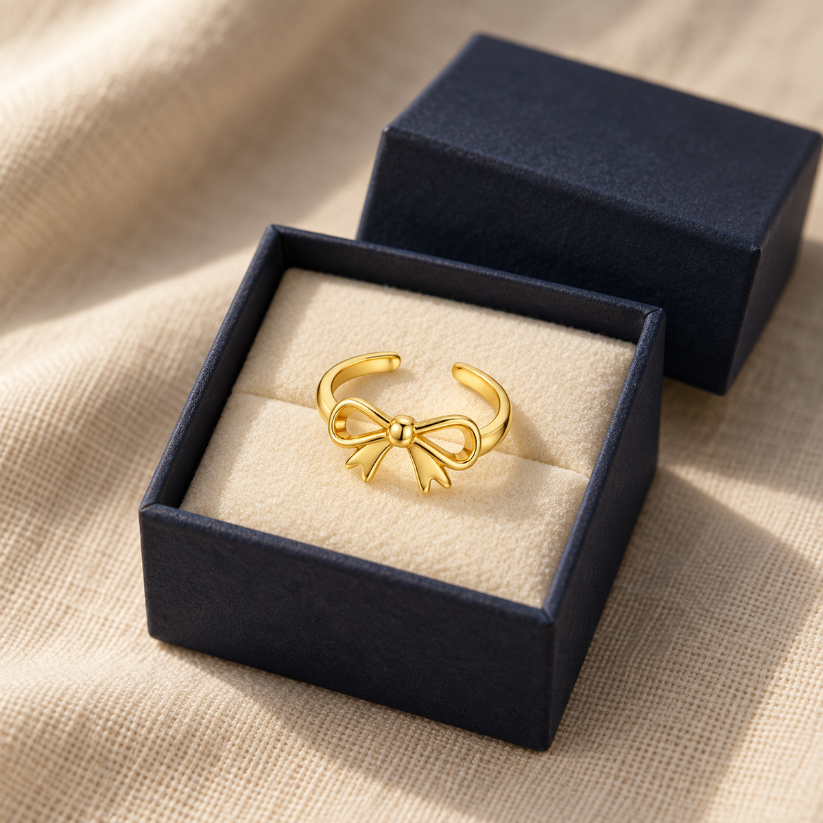 Bow toe ring in an open navy gift box