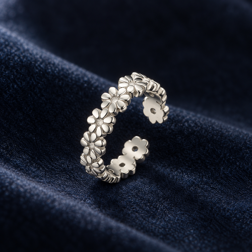 Sterling silver daisy-chain toe ring on deep navy velvet