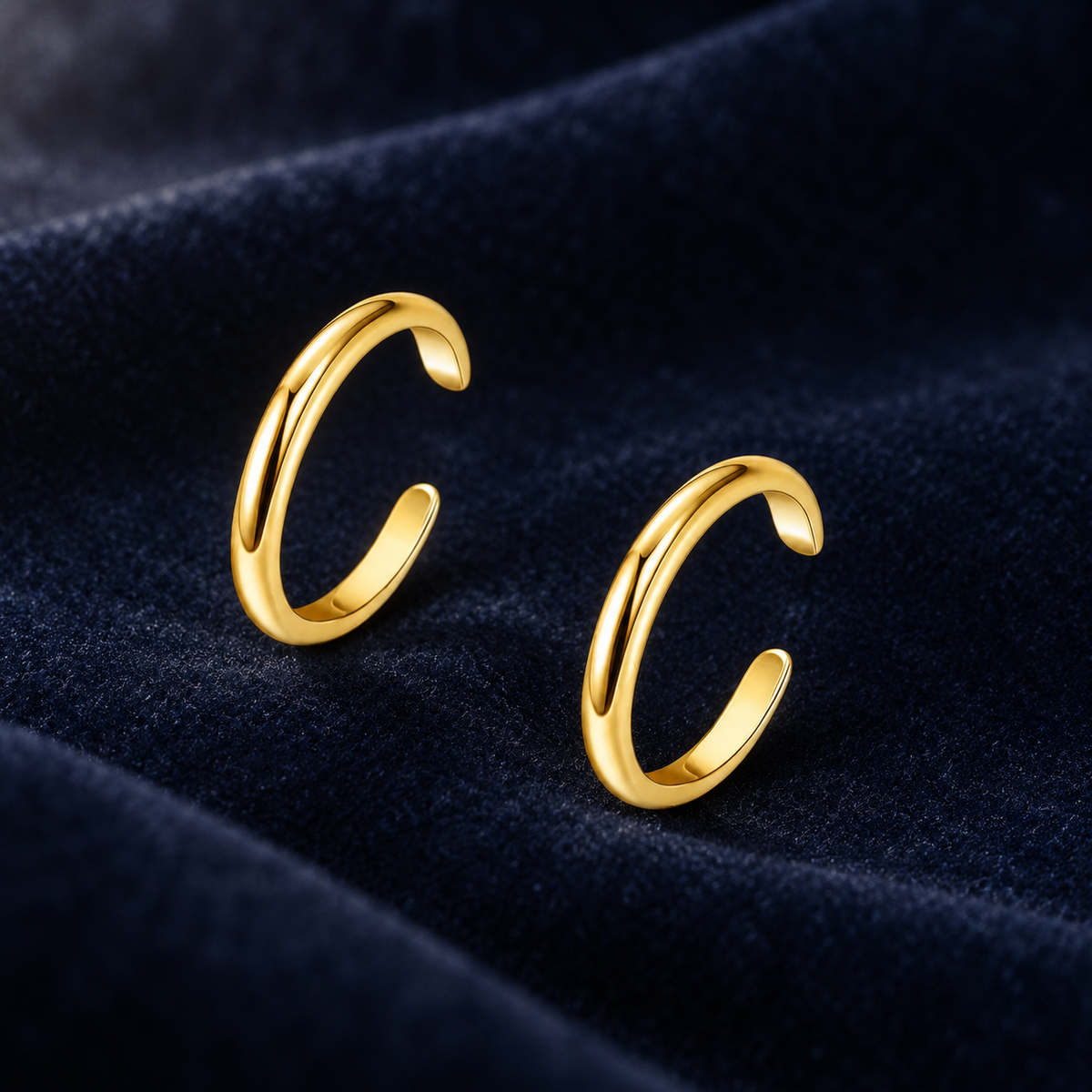 Two-piece adjustable toe ring pair on deep navy velvet