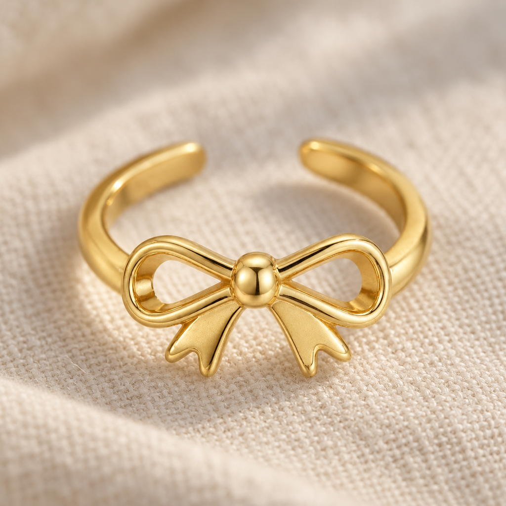 Macro detail of the bow on a gold-tone toe ring